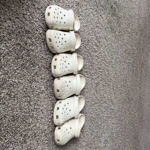 3 pair White Crocs. Two are size 9 and one is size 8.